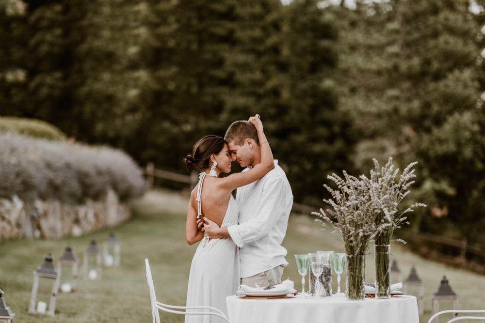 In questa foto una coppia abbracciata e sullo sfondo il giardino esterno di Spao Borgo San Pietro, location per matrimoni di lusso Toscana