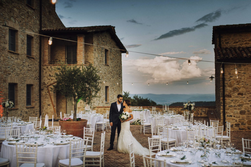 In this photo a married couple in the square of Spao Borgo San Pietro where their wedding banquet is organized