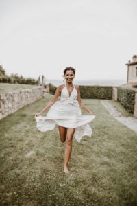 In questa foto una sposa in un momento di spensieratezza nella natura di Spao Borgo San Pietro, location matrimoni di lusso in Italia