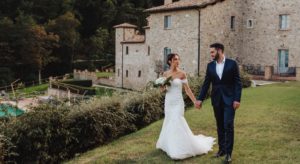 luxury wedding a couple walking in the garden of spao borgo san pietro