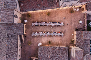 View of the large square of SPAO Borgo San Pietro Aquaeortus set up for the wedding dinner